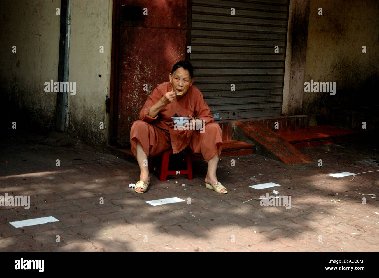Lady eating Vietnamese soup in the street in Hanoi in vietnam Stock Photo Alamy