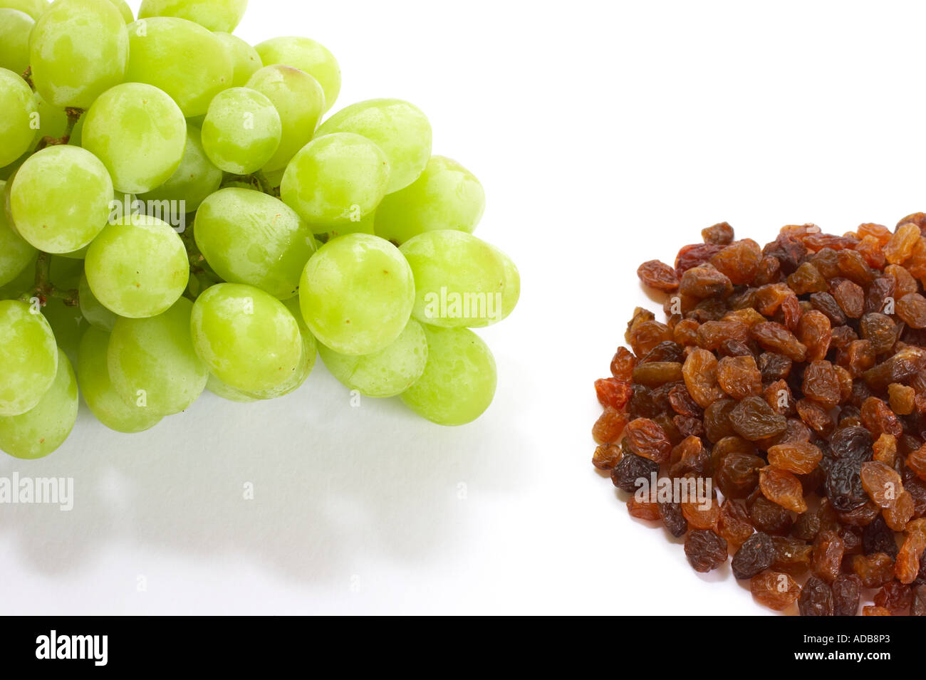 Bunch of grapes and sultanas on white background Stock Photo