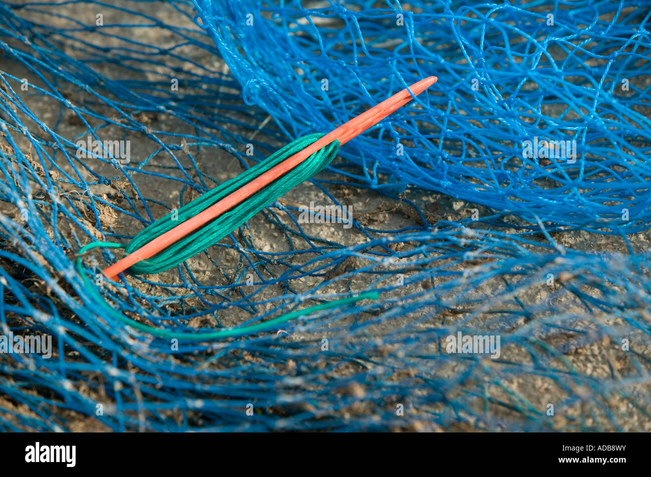 Tool for repairing torn fishing nets Stock Photo Alamy