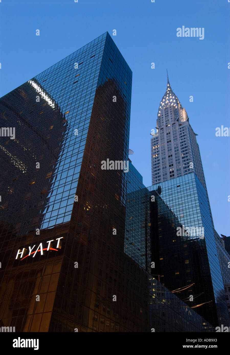 Chrysler Building at twilight with Hyatt hotel in the foreground Stock Photo