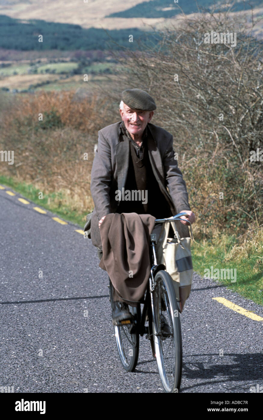 Download elderly man cycling along a narrow irish country lane, old ...