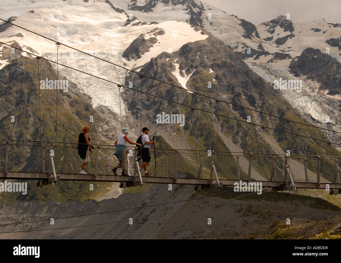 Crossing suspension bridge Hooker River Mount Cook National Park South Island New Zealand Stock