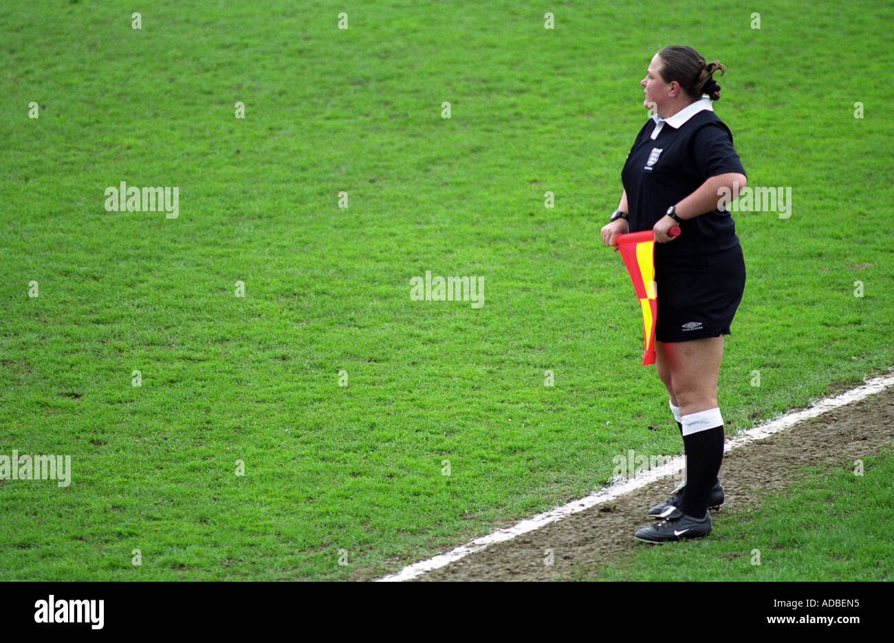 Referee's assitant running the line at a football match in Harwich, Essex, UK. Stock Photo