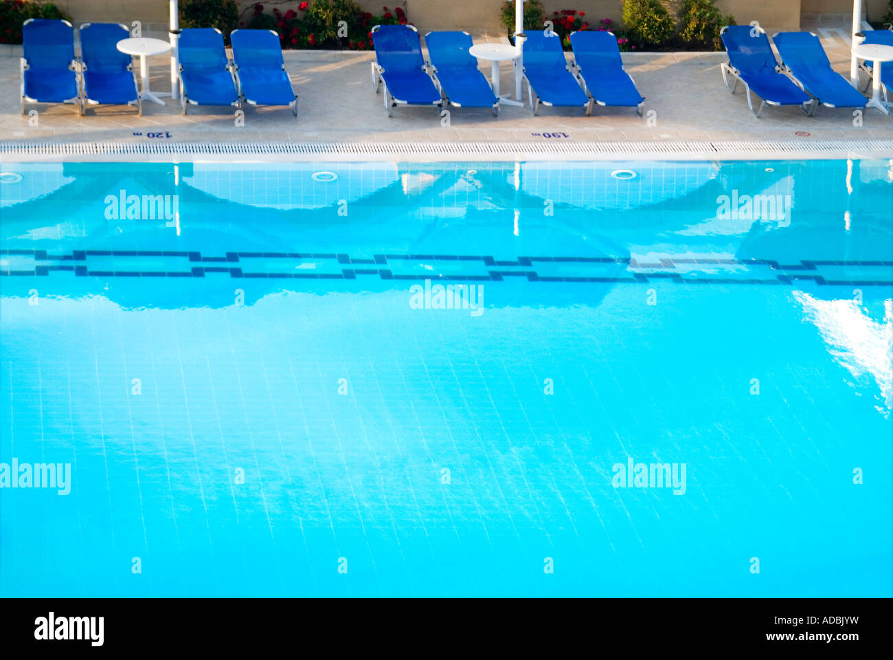 Horizontal aerial view of an inviting outdoor swimming pool surrounded ...