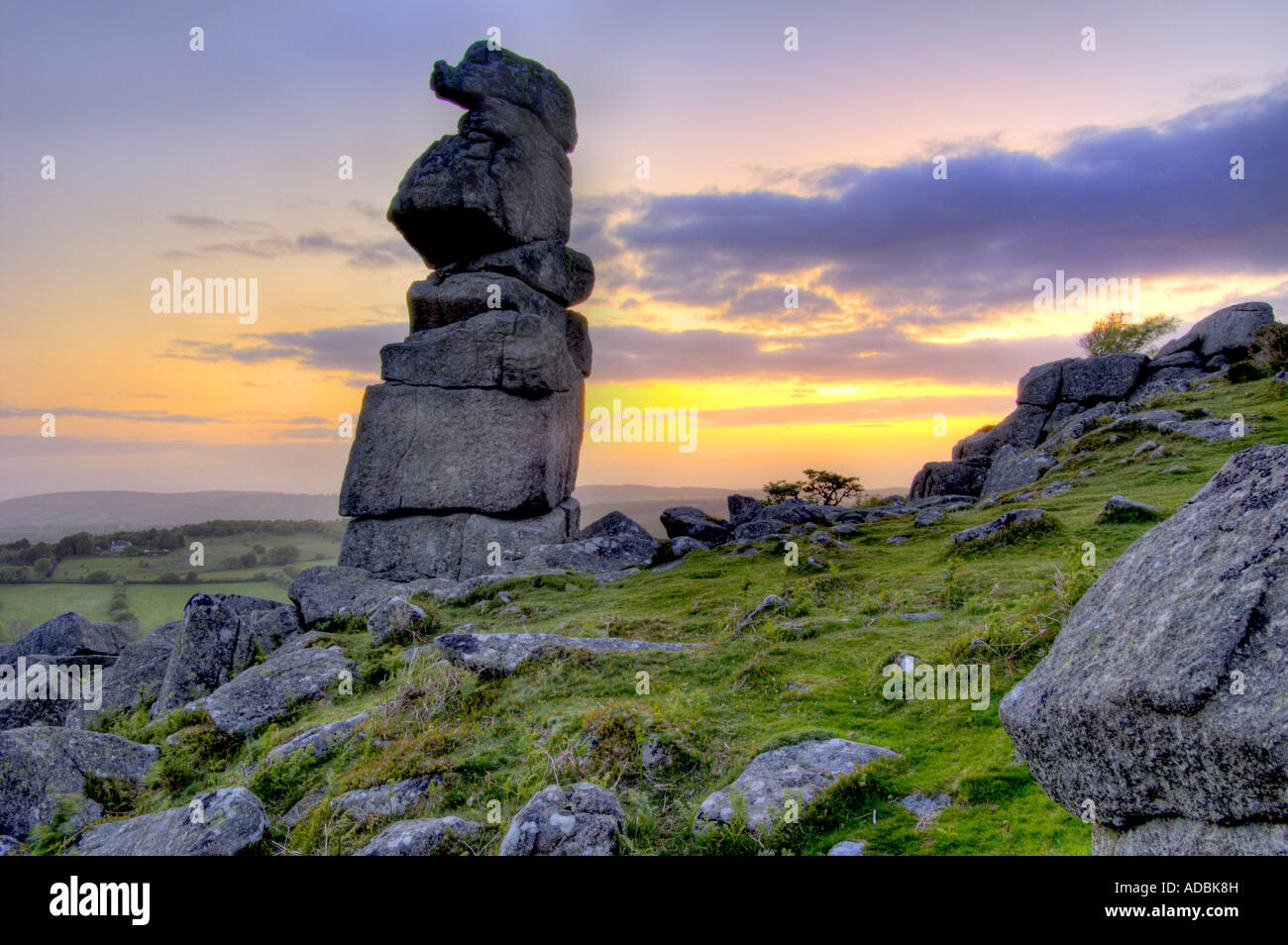 Bowermans Nose granite rock formation near Hayne Down on Dartmoor with the sun rising directly behind Stock Photo