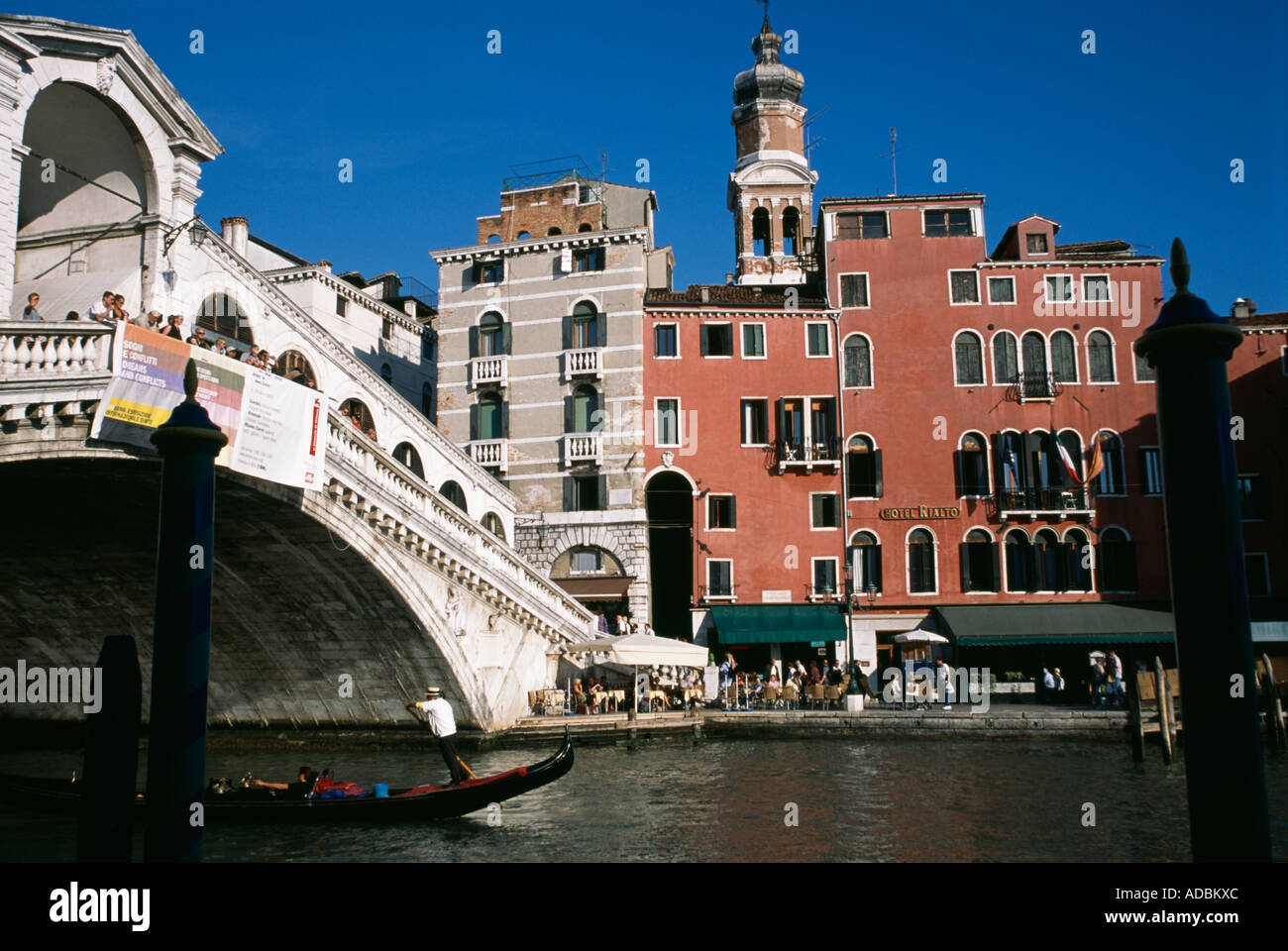 Gondolier and the iconic Rialto Bridge Grand Canal Venice Italy Stock Photo