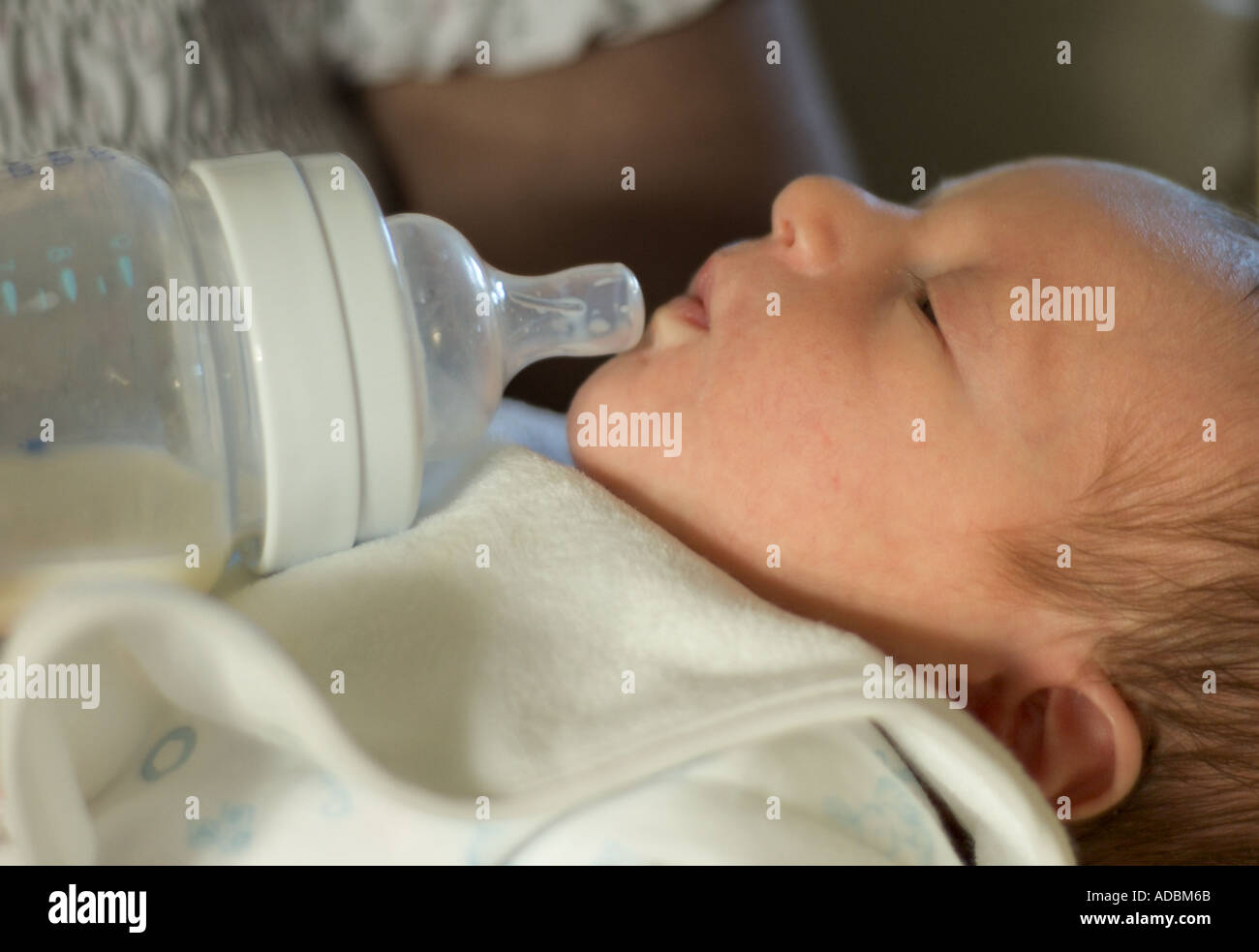 Mother feeding new born baby with bottle Stock Photo