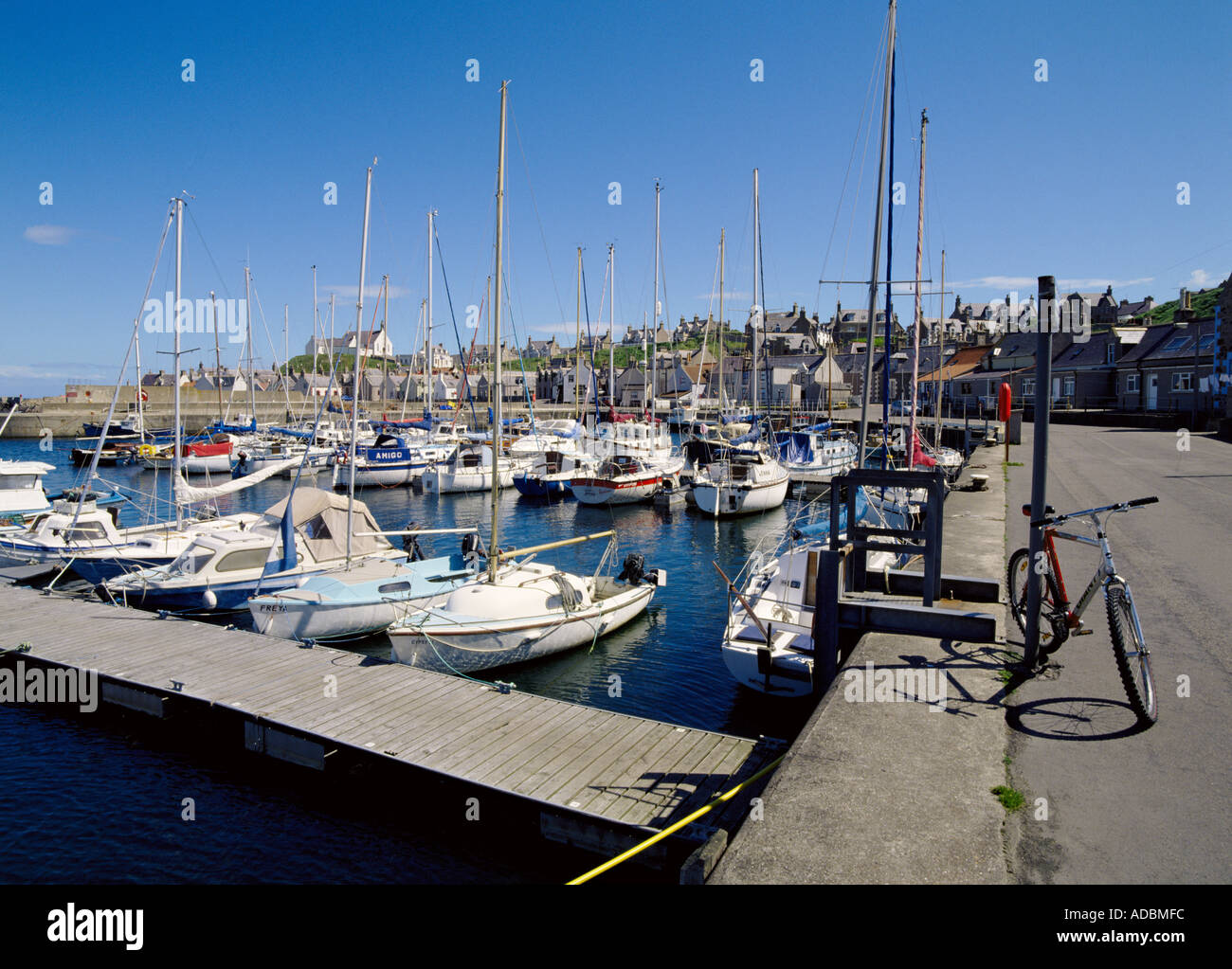 dh  FINDOCHTY MORAY Yachts in harbour bicycle and fishing village cycle parked scotland biking Stock Photo