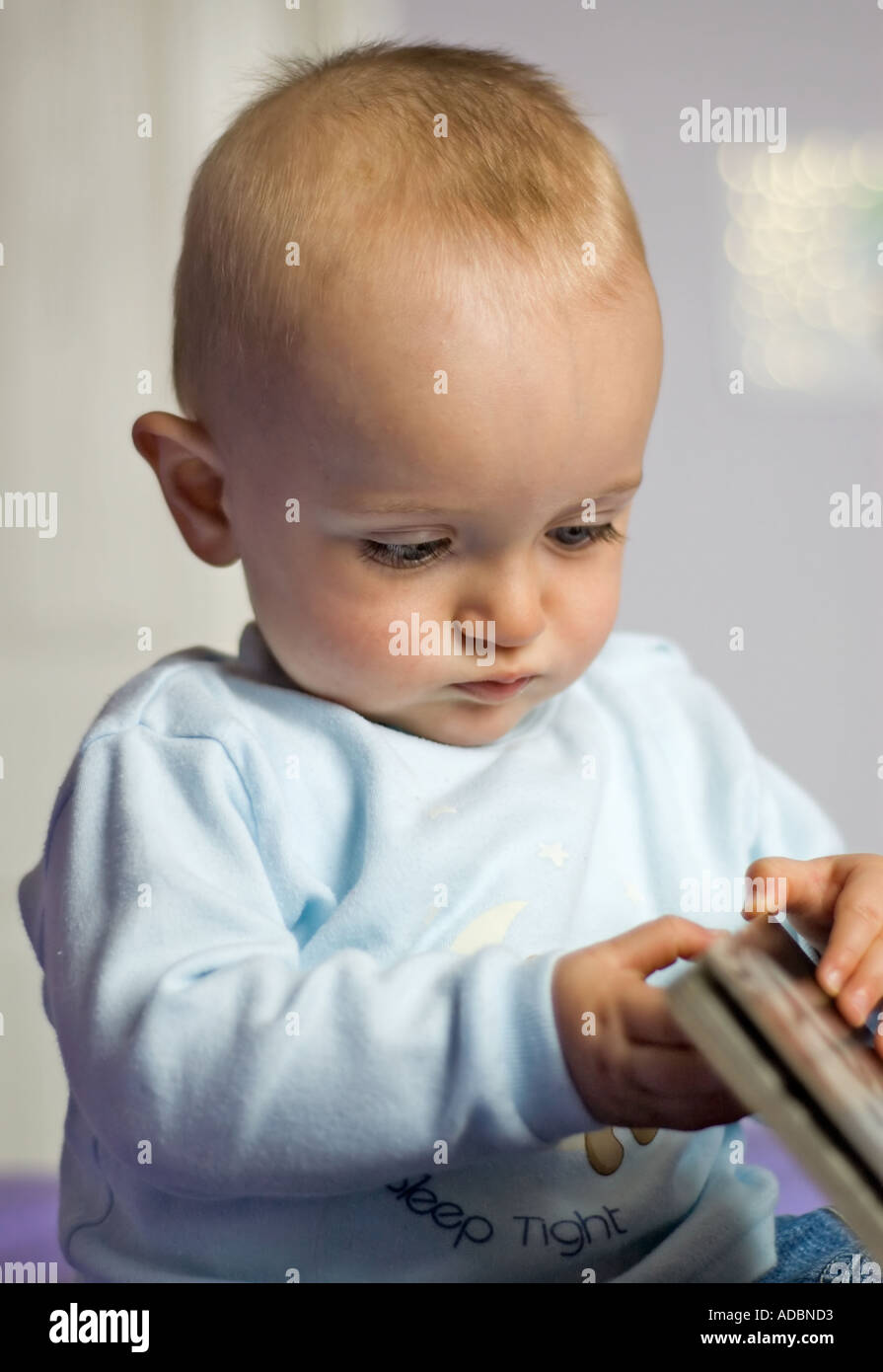 9 month old baby boy reading a book Stock Photo Alamy