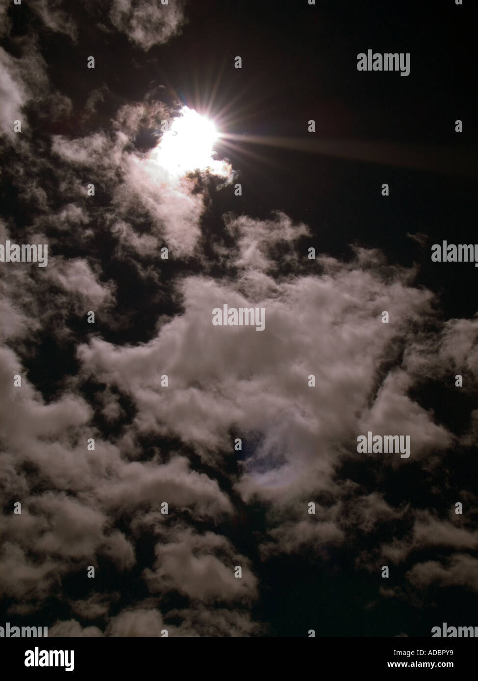 Clouds with sunburst and dramatic dark stormy summer sky Stock Photo