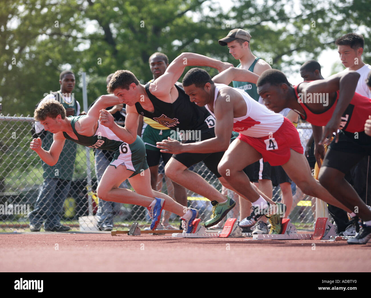High school track athletes leave the starting line during the 100 meter finals of the  Connecticut State Class LL State Open Stock Photo