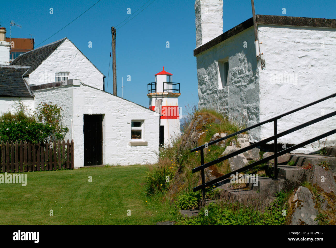 The harbour light and cottages at Crinan Stock Photo