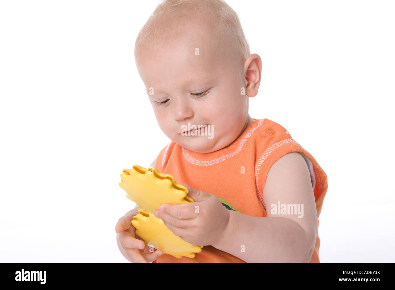 Sitting little boy with a toy Stock Photo - Alamy