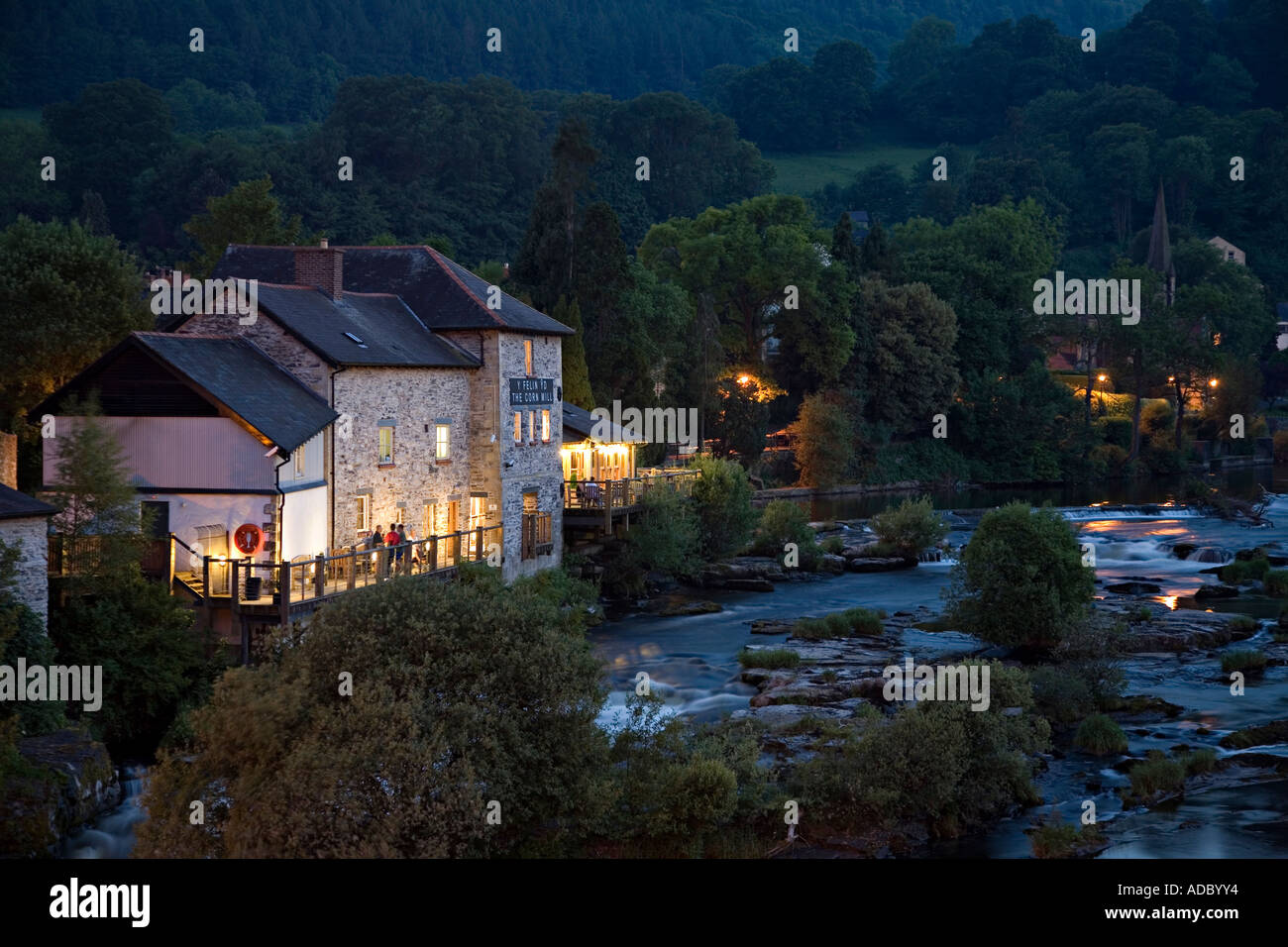 The Corn Mill public house beside the River Dee at dusk Llangollen