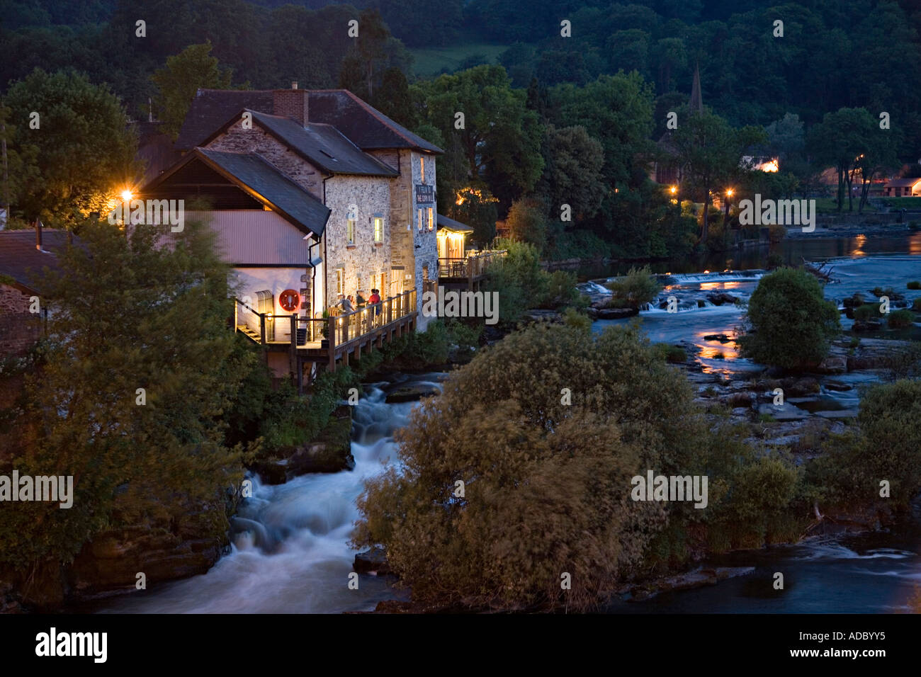 The Corn Mill public house beside the River Dee at dusk Llangollen