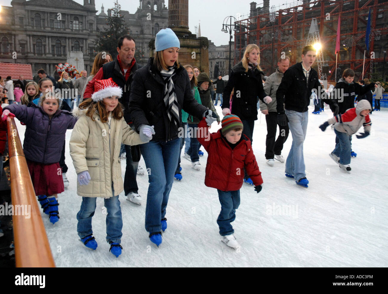 Ice Skating on Outdoor Ice Rink, Square. City Chambers in