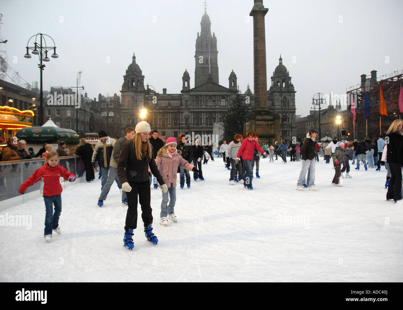 Ice Skating on Outdoor Ice Rink, George Square. City Chambers in Background. Glasgow. Scotland. Xmas Stock Photo