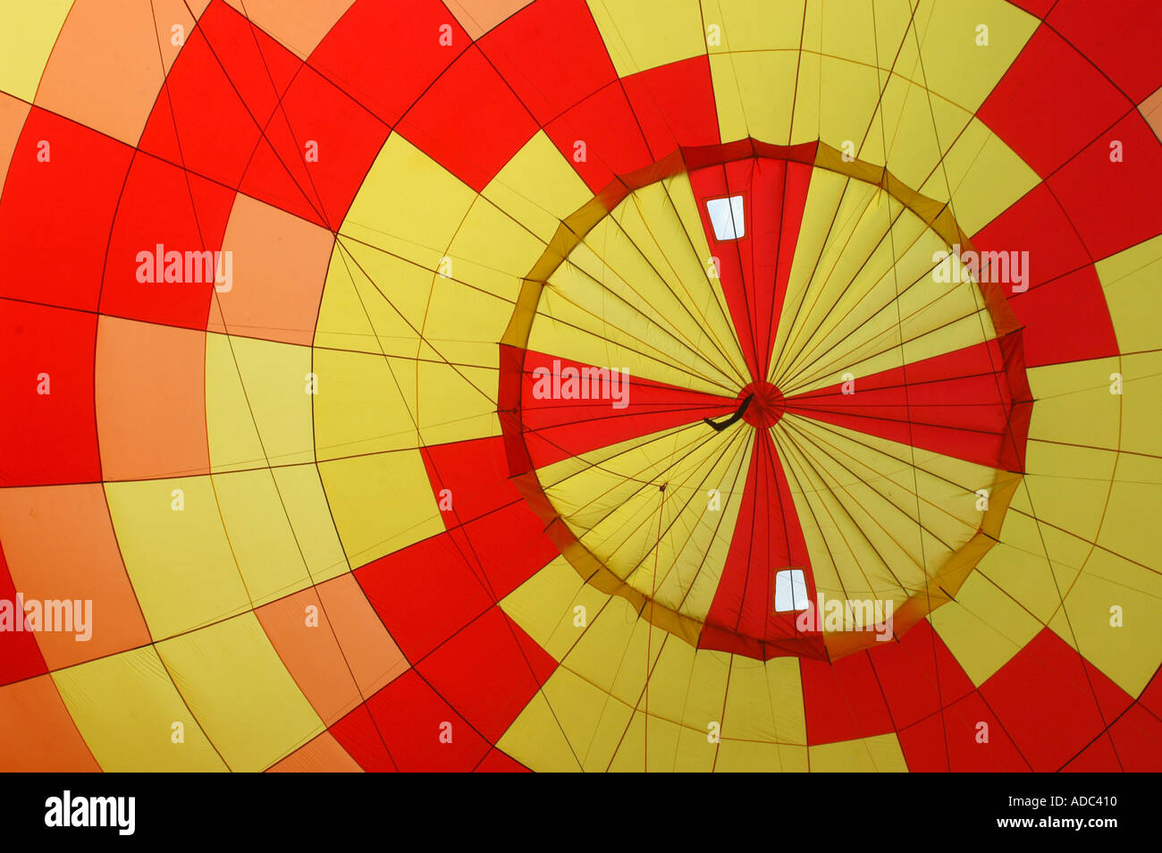 Red and yellow hot air balloon being inflated Stock Photo - Alamy