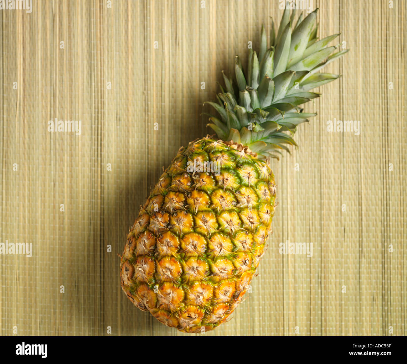 Pineapple on a Straw Mat in Hawaii Stock Photo