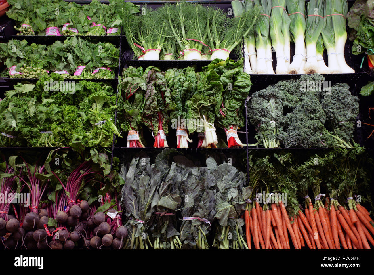 Organic Foods in a supermarket display case. Healthy eating health foods. Greens Stock Photo