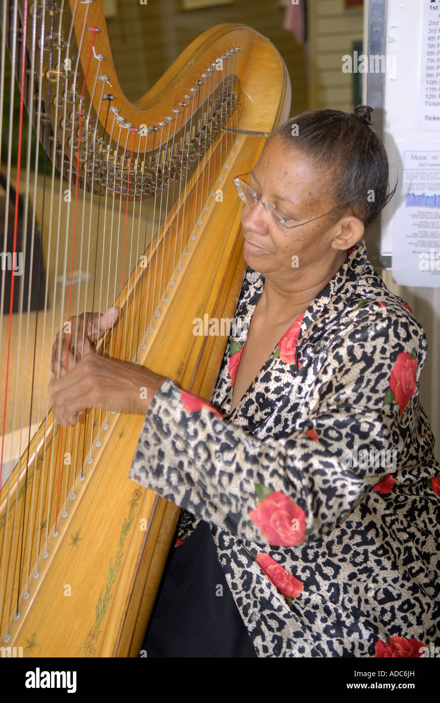 Black female playing the harp Stock Photo Alamy