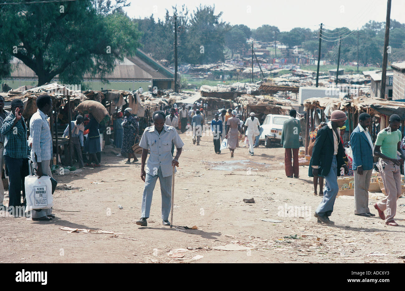 People and vehicles on a busy unmade street in a slum area of Nairobi Kenya East Africa Stock Photo