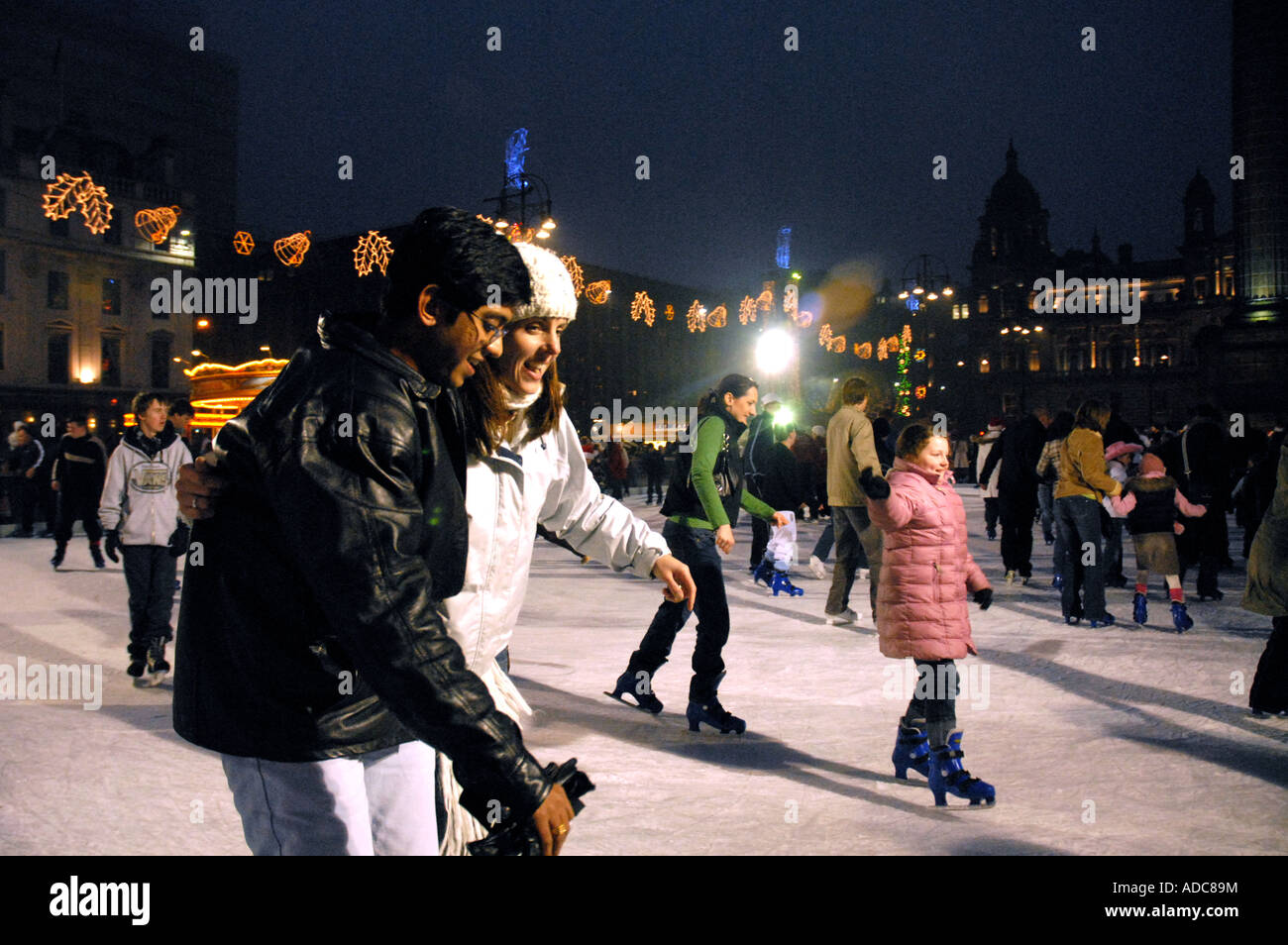 Ice Skating on Outdoor Ice Rink, Square. City Chambers in