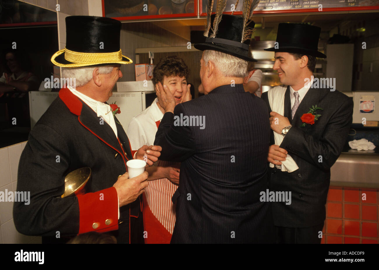 Hungerford Hocktide, takes place on second tuesday after Easter. 1980s UK. Tuttimen kissing the women girls in exchange for an orange. HOMER SYKES Stock Photo