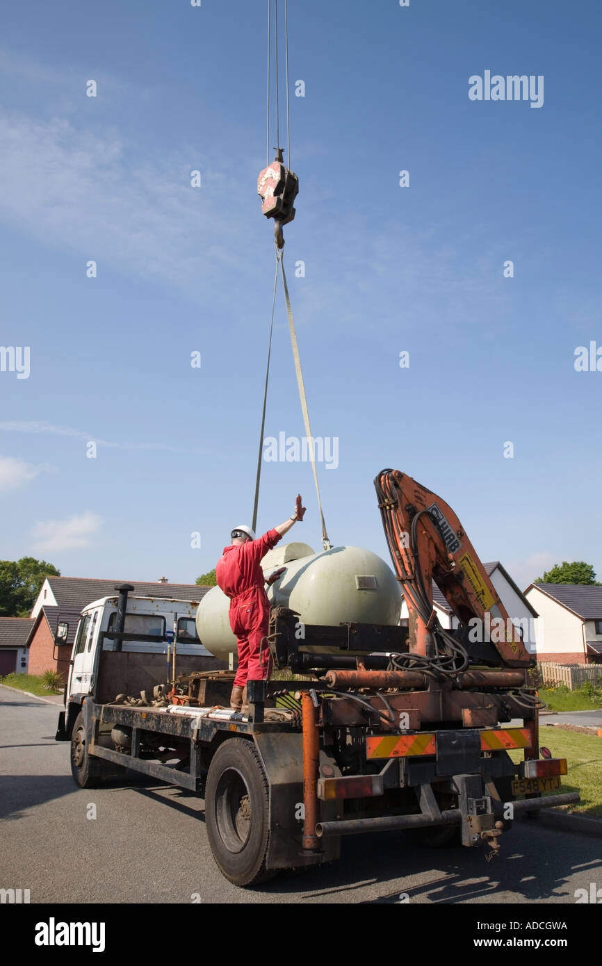 Calor gas tank being lowered on to a lorry by a crane. UK, Britain. Stock Photo