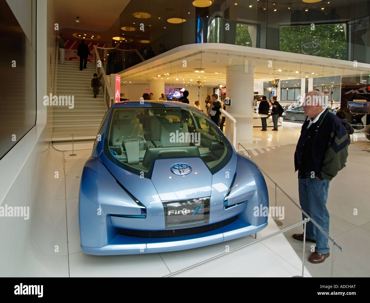 Man looking at futuristic looking Toyota Fine N hybrid concept car in the Toyota flagship showroom in Paris Stock Photo