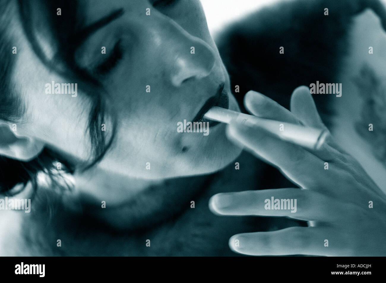 Woman smokes cigarette hi-res stock photography and images