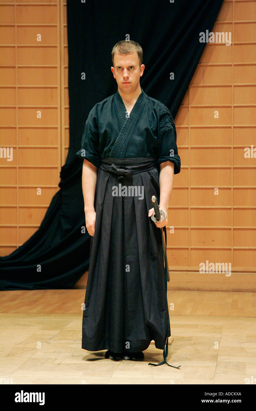 man knight samurai sword kimono gi fighter warrior sport hobby lifestyle  people look at serious black strong Stock Photo - Alamy
