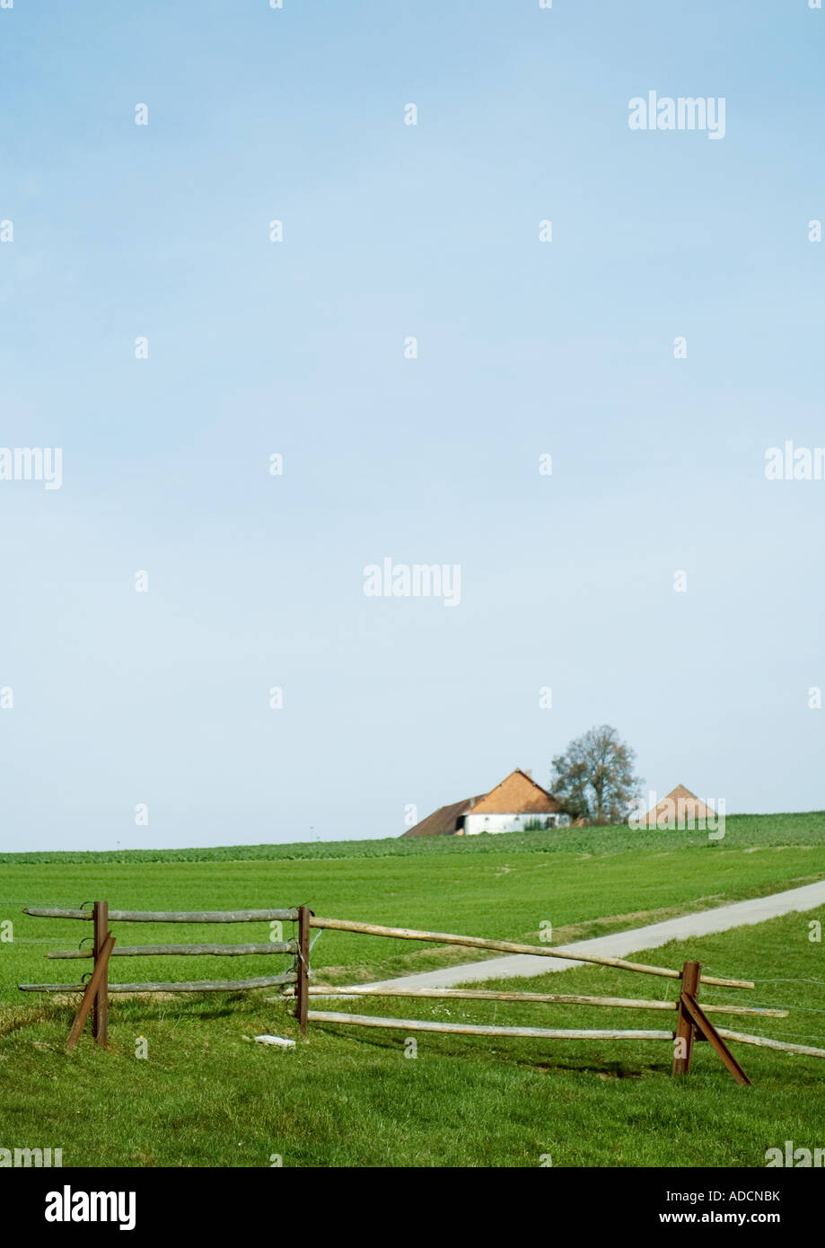 Landscape with farm house and wooden fence Stock Photo - Alamy