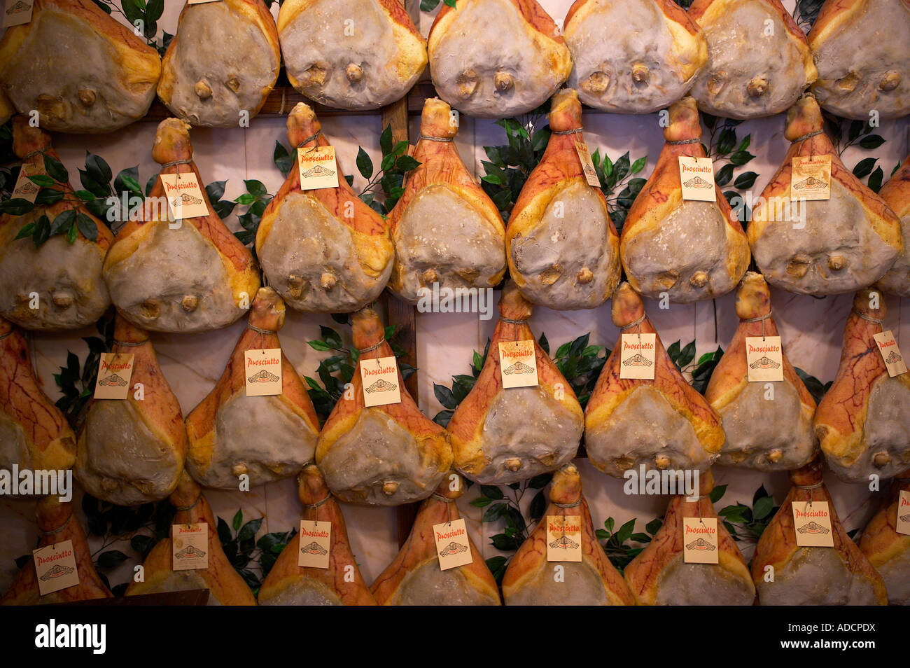 hams hanging in a shop in Norcia selling local produce Umbria Italy NR ...