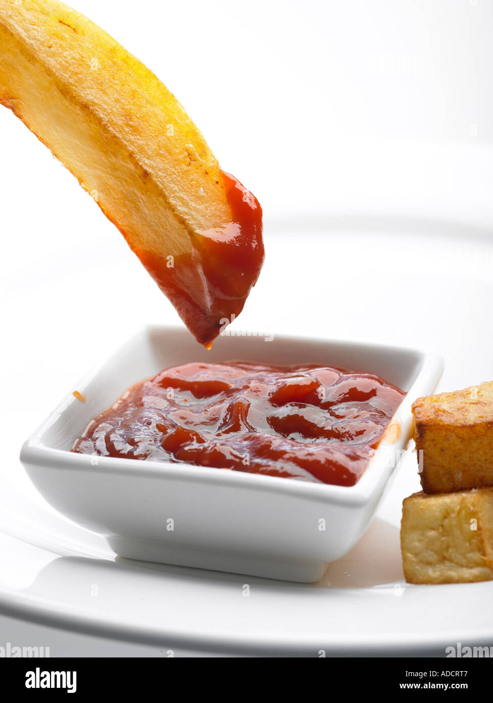 chunky chip dipped into tomato sauce ketchup Stock Photo Alamy