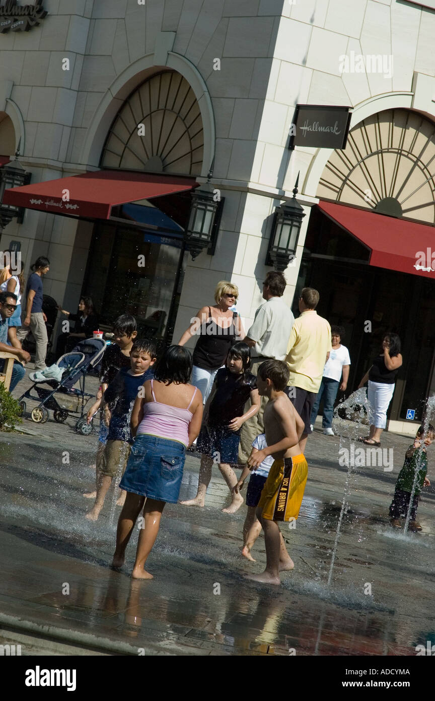Kids playing and getting wet outside during the summer of 2006 heat