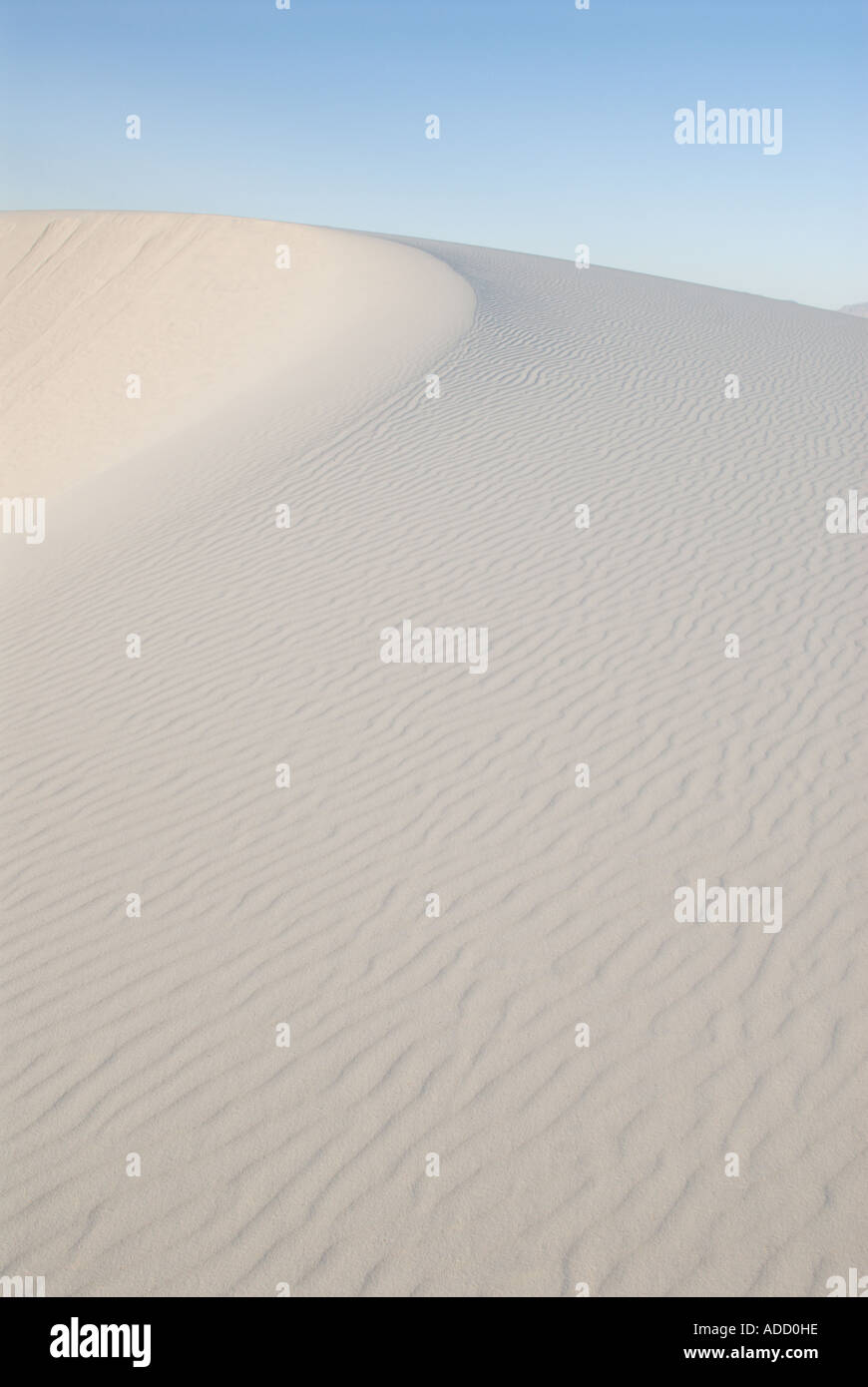 Crest of a crescent dune with blue sky at White Sands National Monument