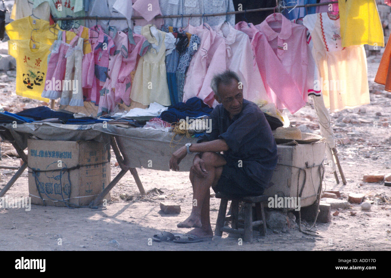 Man selling clothes street market hi-res stock photography and