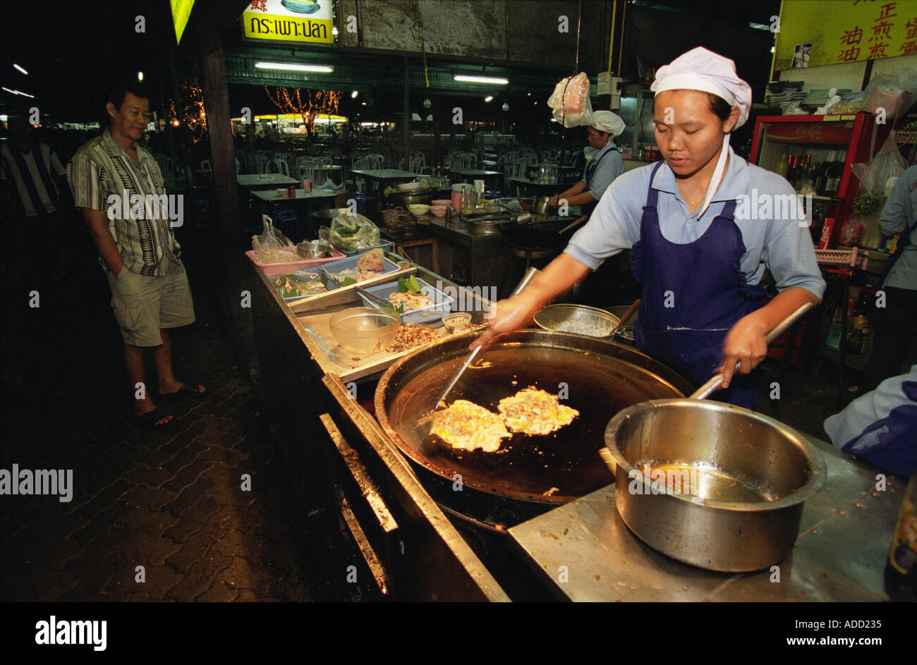 Cooking a meal in a food stall at Anusarn Market Chiang Mai Thailand Stock Photo