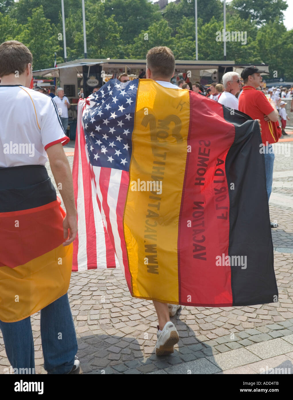 A football fan wearing a German and an American flag on his back at a public viewing event Stock Photo