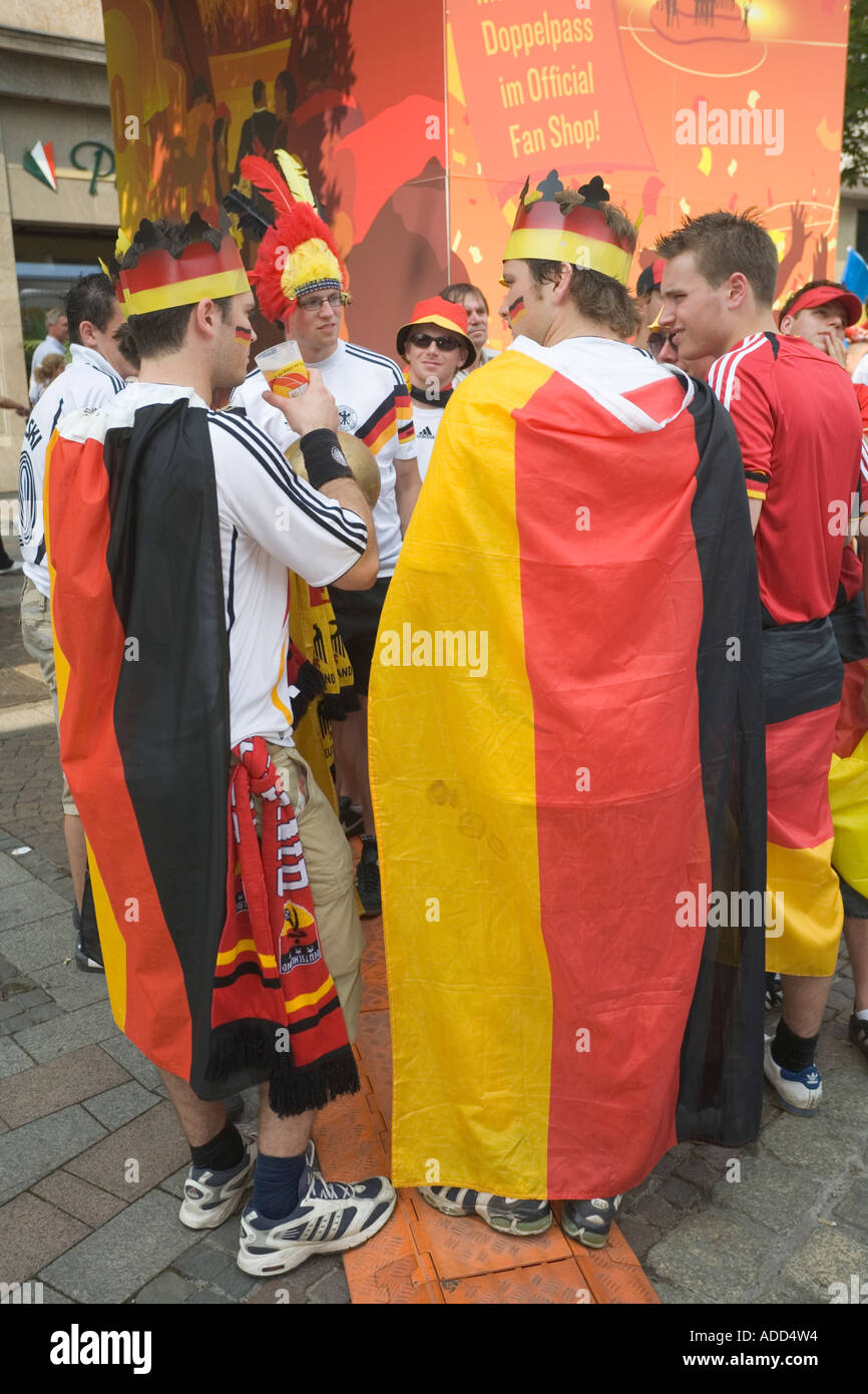 German football fans standing together with their flags at a public viewing event Stock Photo