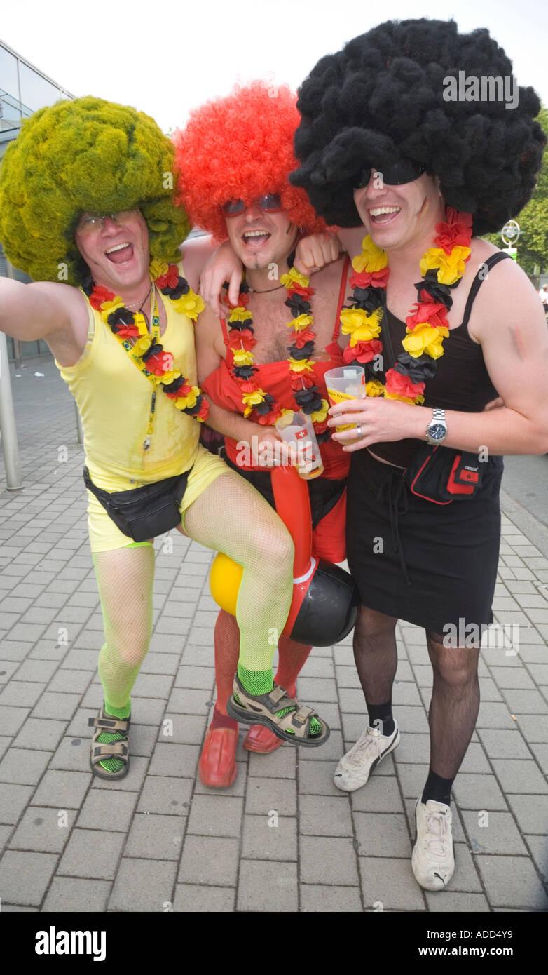 Three German football fans cheering in good mood Stock Photo