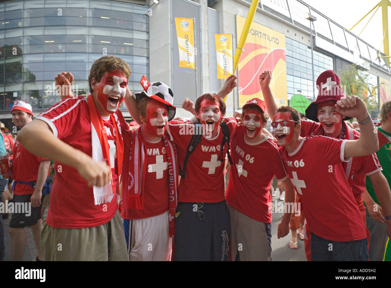 Swiss football fans cheering in good mood in front of the Dortmund world cup stadium Stock Photo