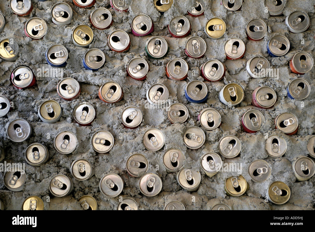 Empty cans of soda and beer are used as insulation in walls during a