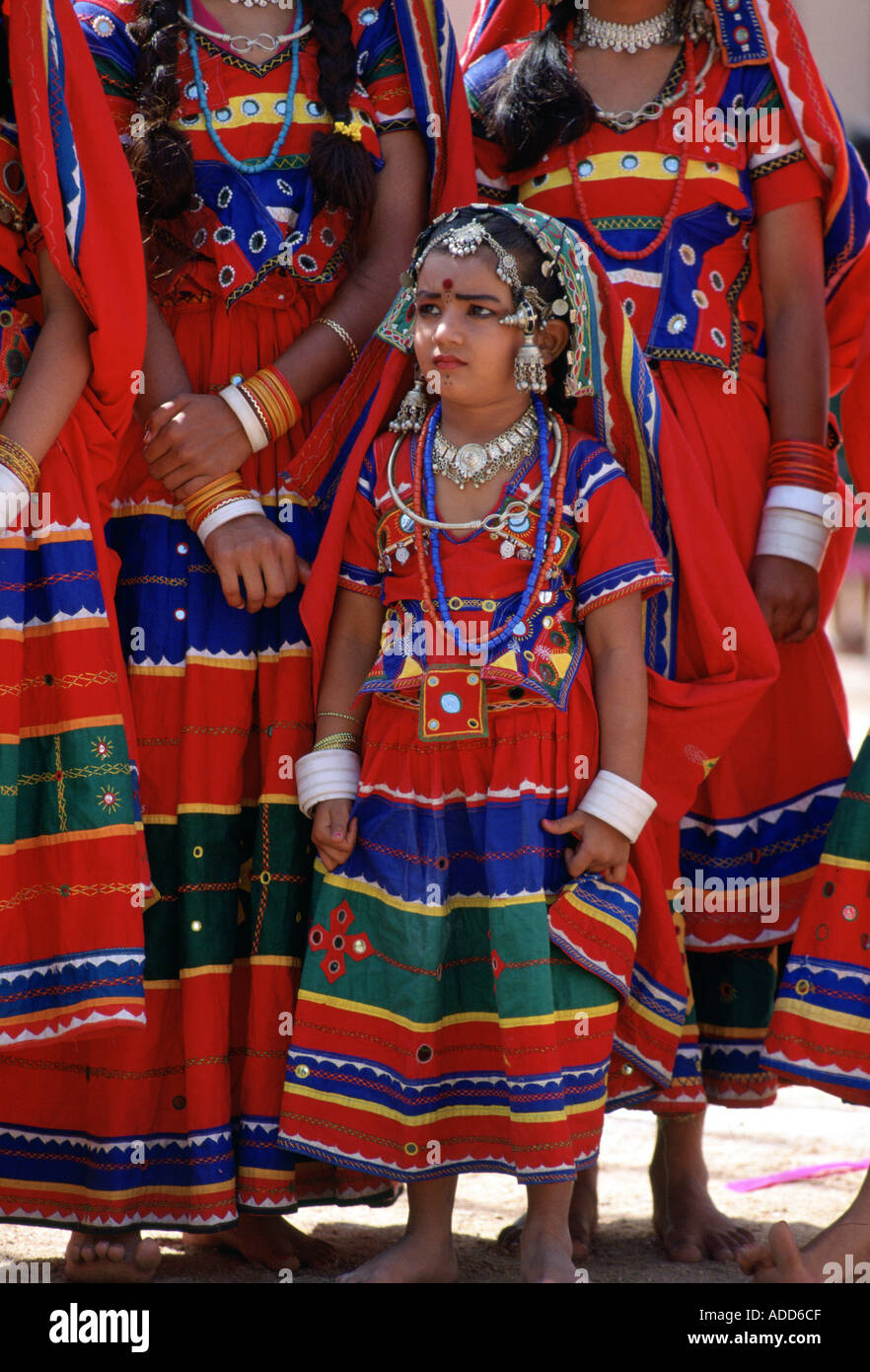 Pretty young girls in brightly coloured national costume and jewels at a festival in Calcutta India Stock Photo