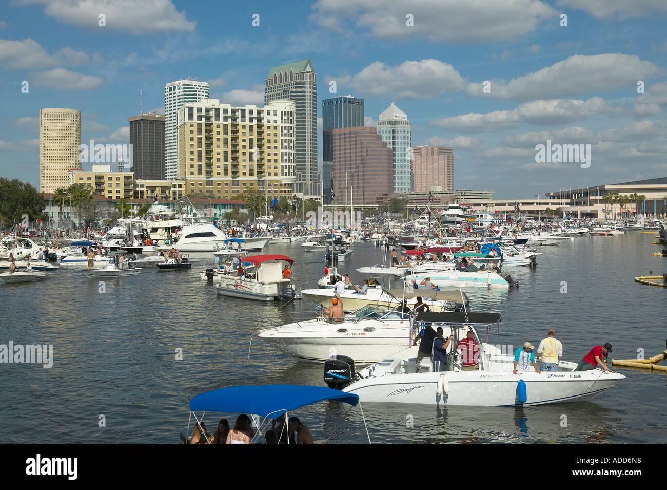 Crowd of boats and boaters along Bayshore boulevard for Gasparilla Pirate Festival Tampa Florida, downtown in background Stock Photo