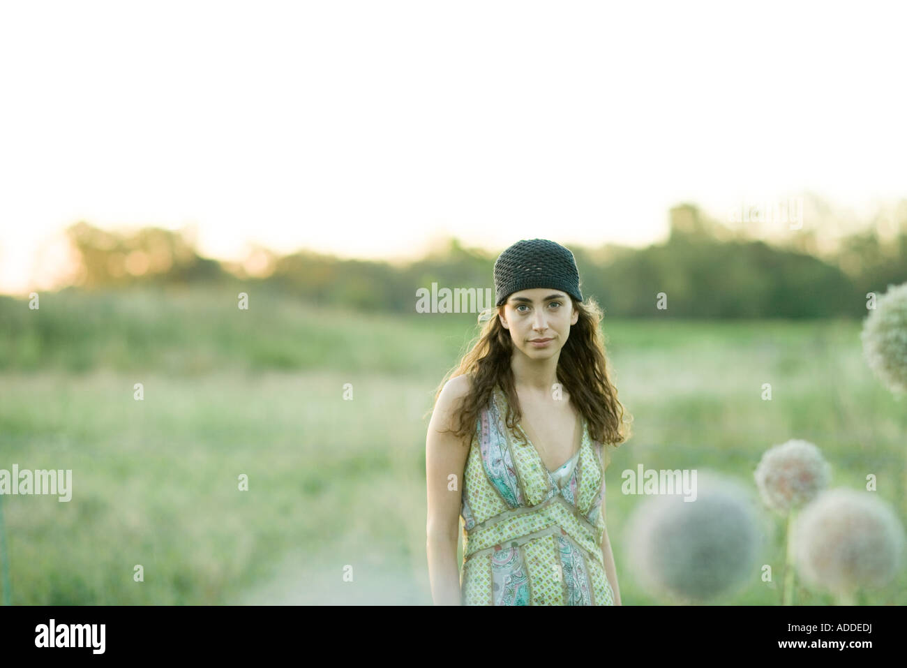 Young woman standing in field Stock Photo - Alamy
