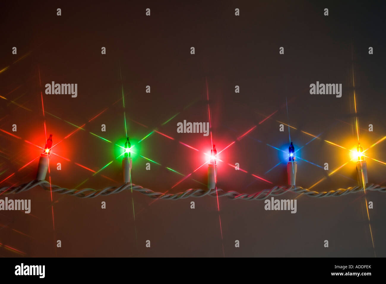 One white strand of multi colored Christmas tree lights shining in