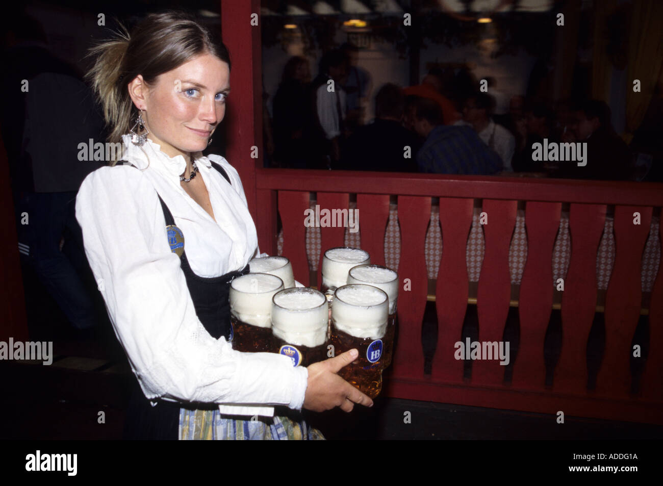 Oktoberfest waitress carrying beer jugs Munich Stock Photo