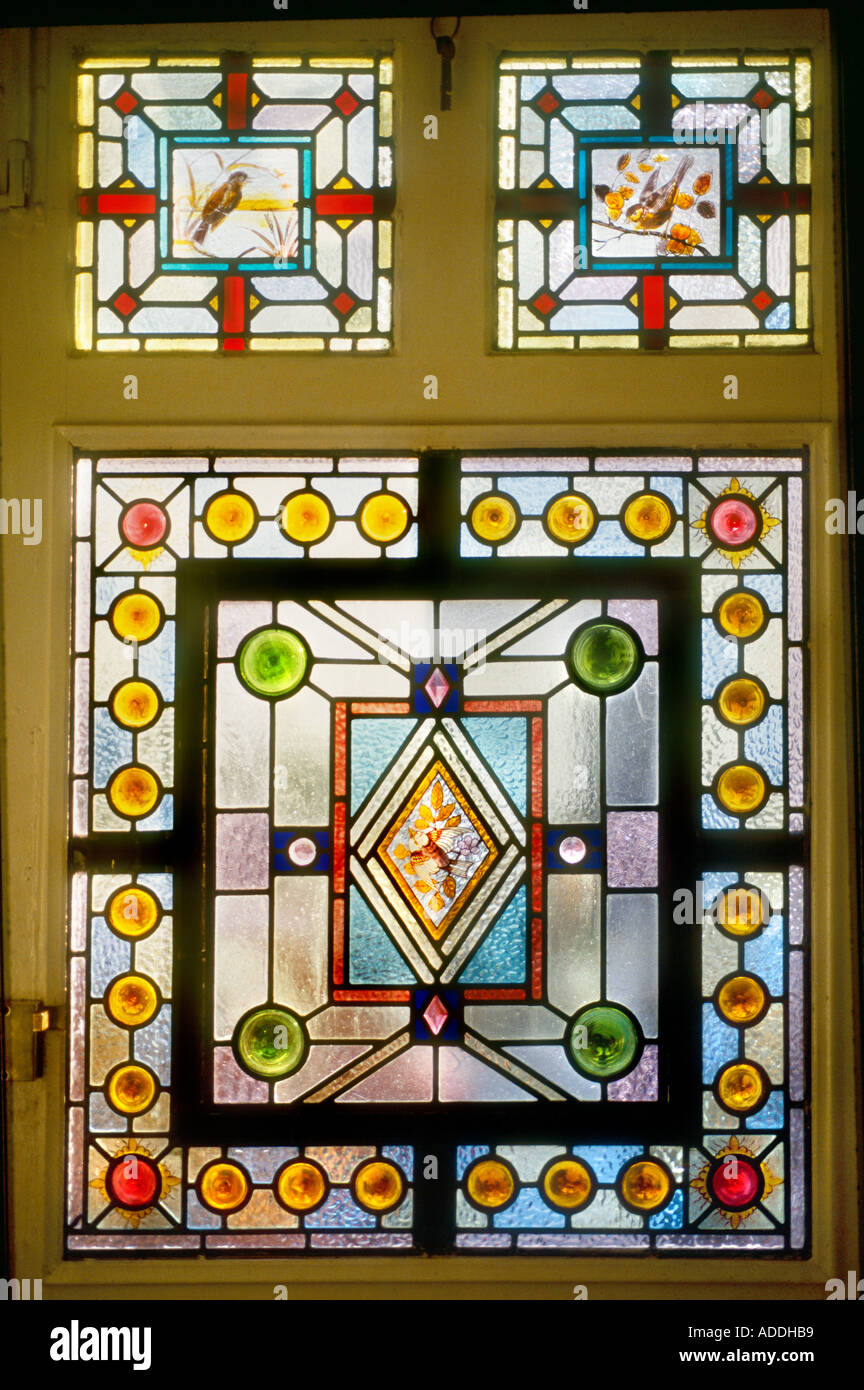 Decorative Stained Glass panel hand painted Victorian geometrical bird design British Housing London Stock Photo